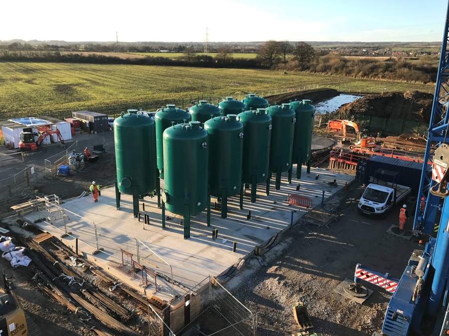 Outdoor granular activated carbon pressure contactor installation of 10 epoxy-coated contactor vessels on a reinforced concrete pad at a drinking water treatment works under construction