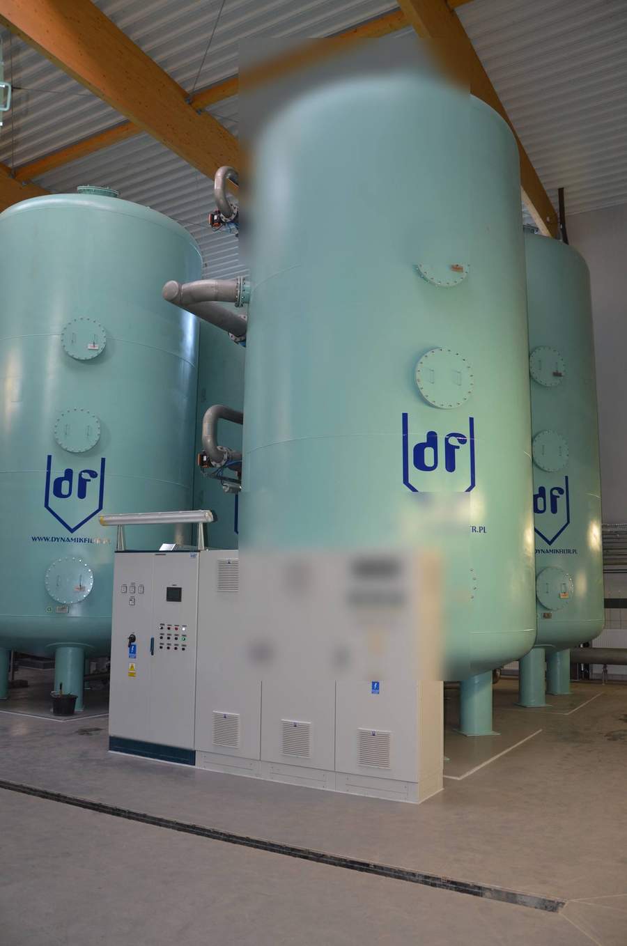 Horizontal pressure filter vessels in green-coated carbon steel with multiple top-access manways and PLC automation control panel